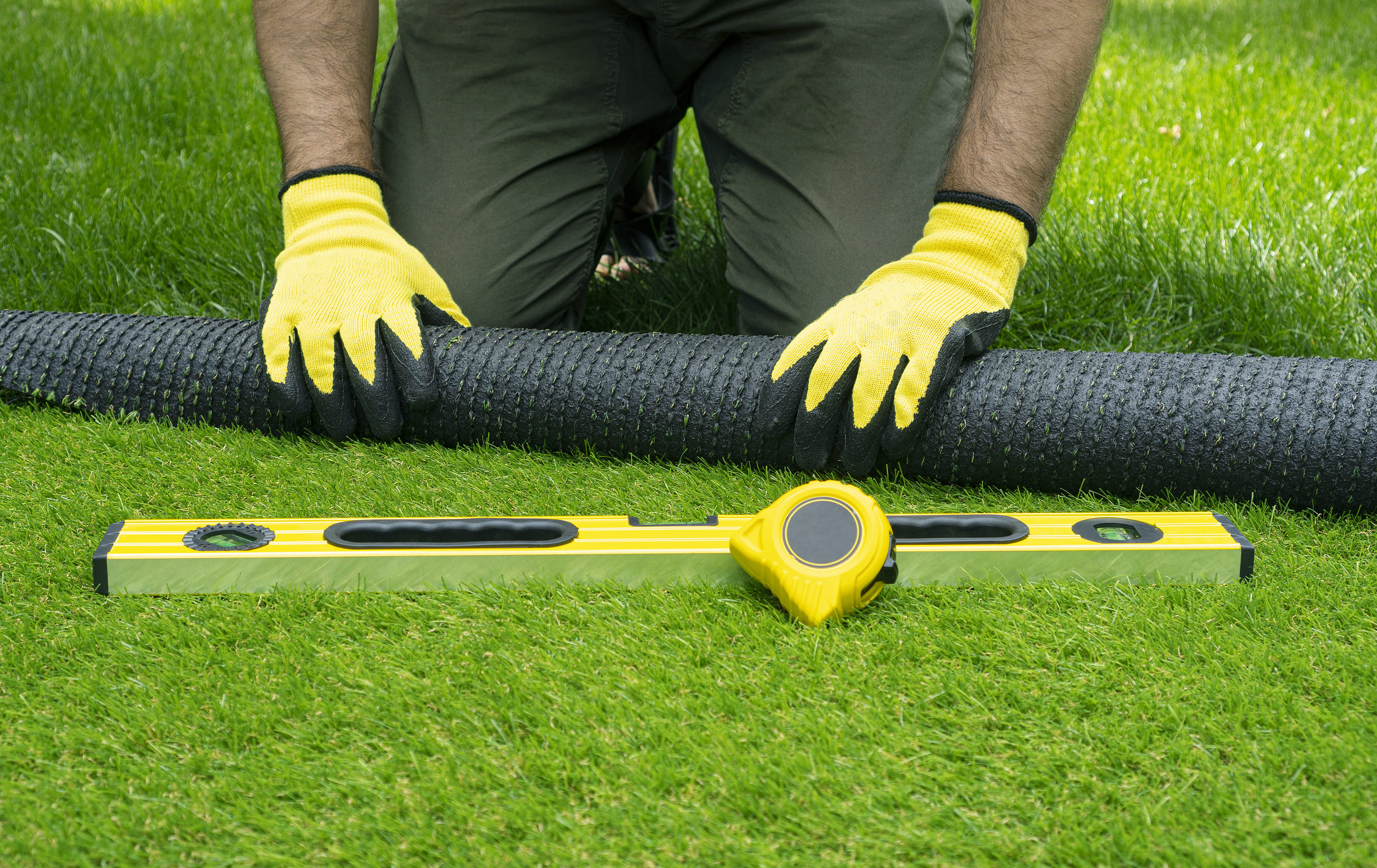 laying down artificial grass