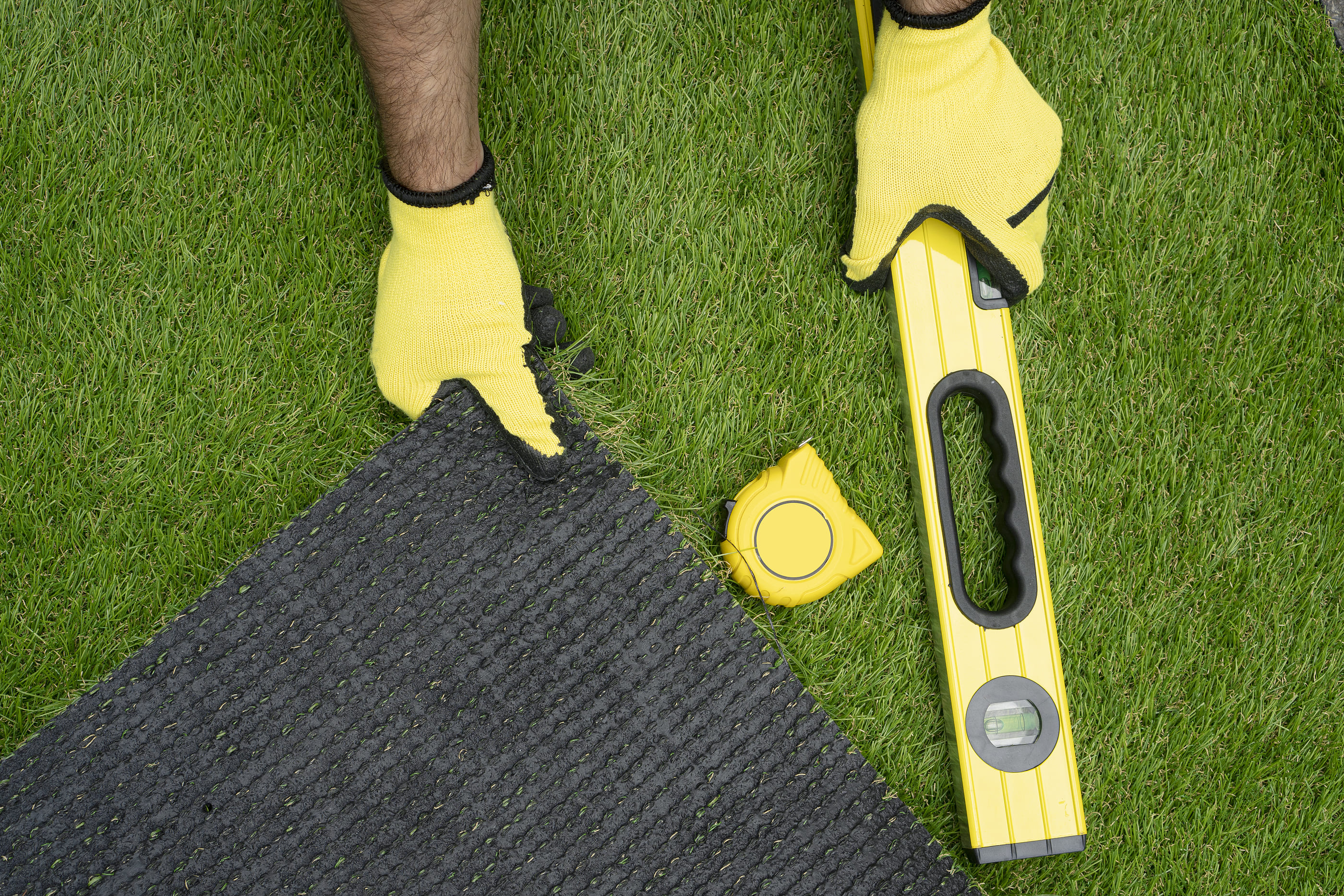 laying down artificial grass